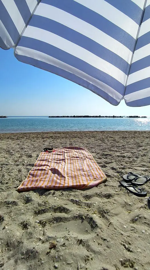 Towel and umbrella on a beach