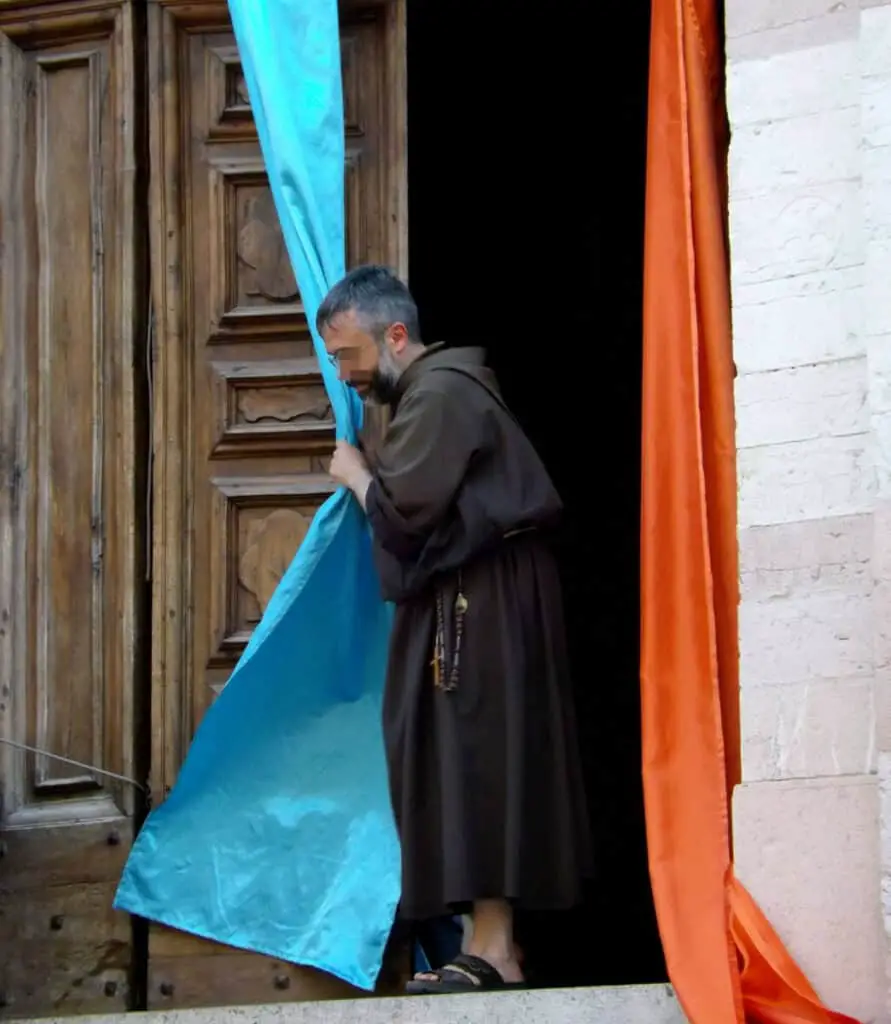 Monk decorating church door for a procession